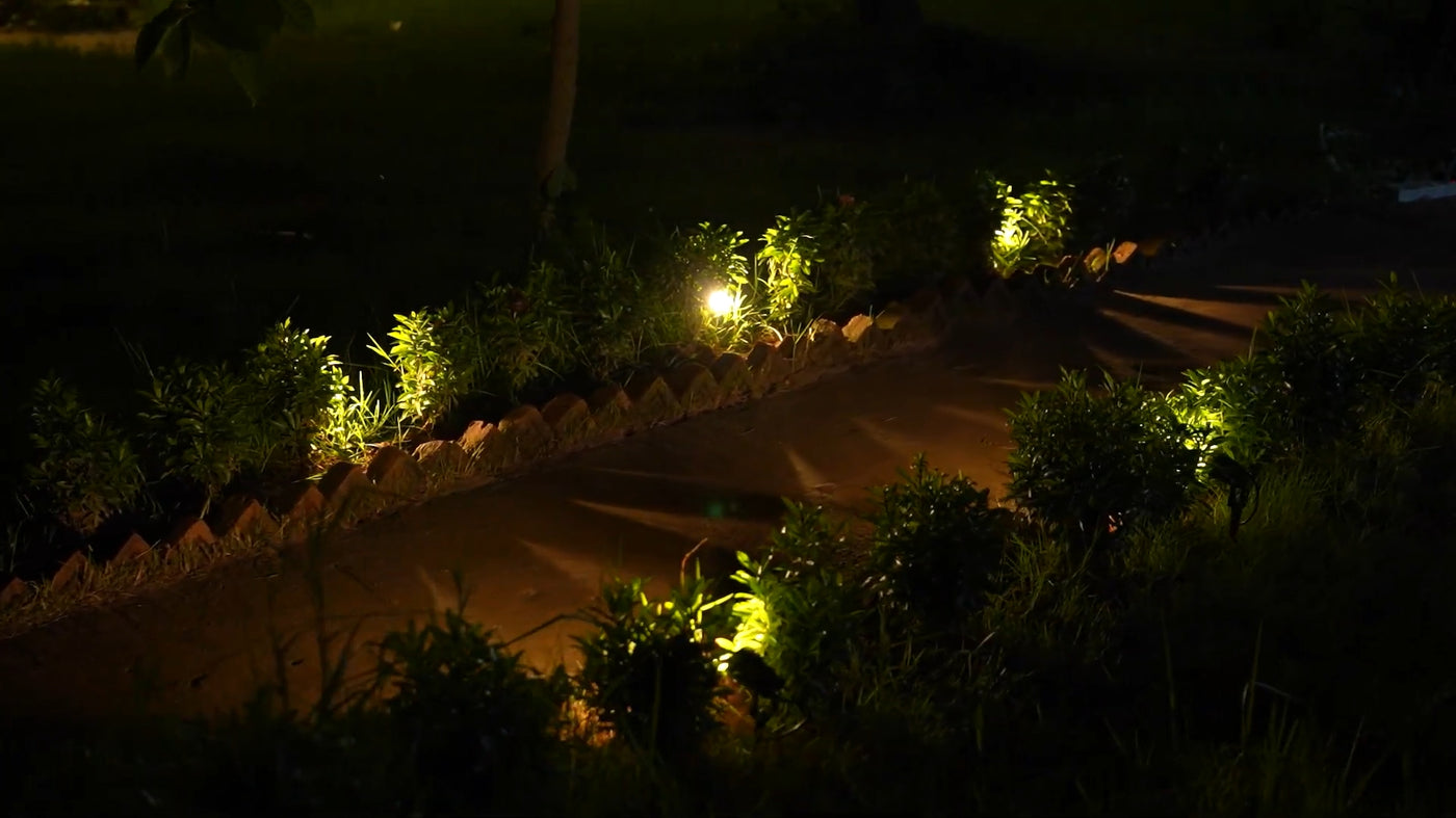 Night garden path glows evenly; landscape lighting wire powers border spotlights with stable low voltage and weather-resistant jacket.