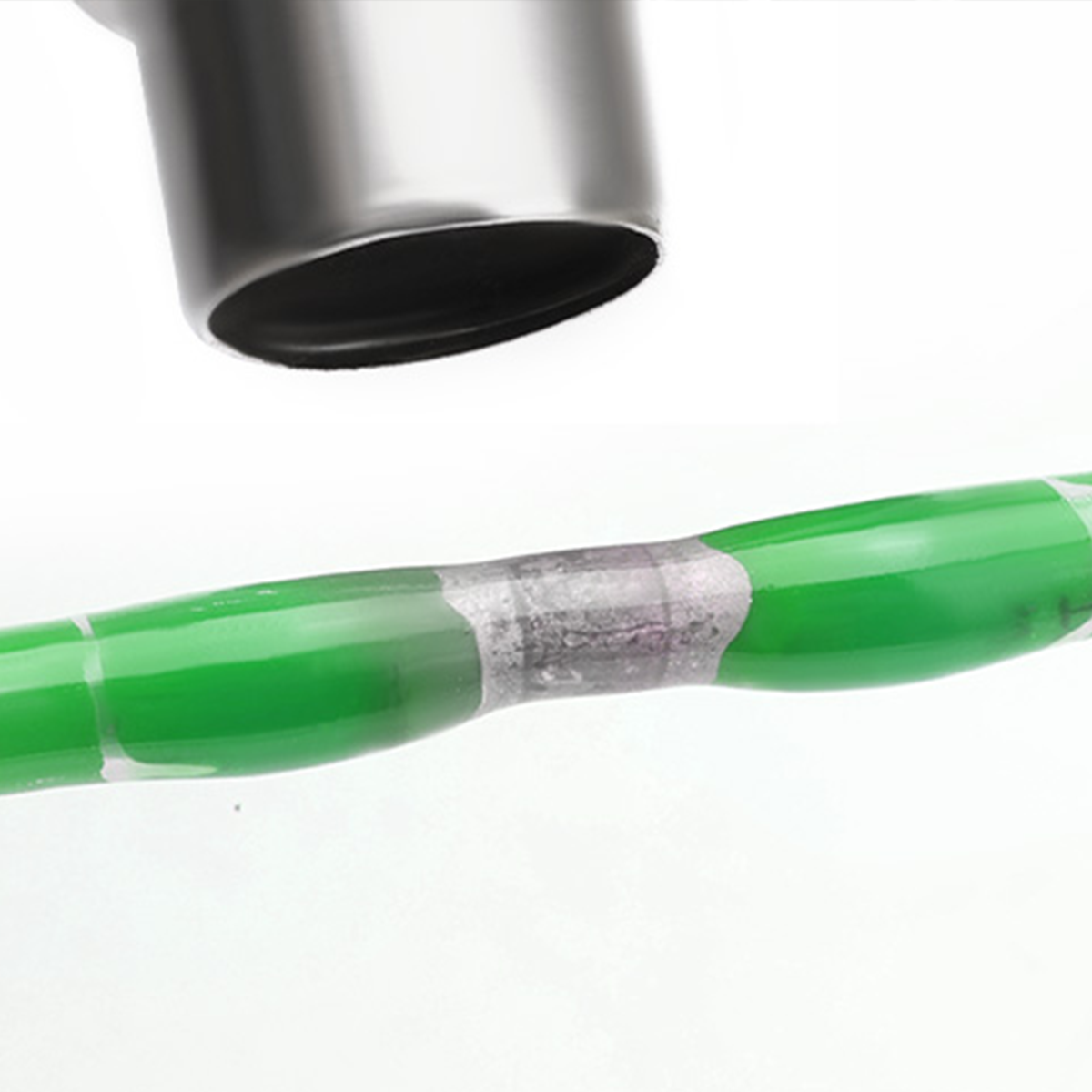 Solder butt splice on green wire with metallic tool and heat-shrink tubing. Precision joint.