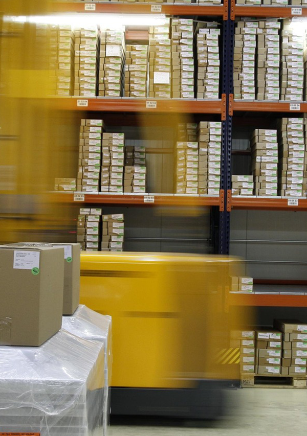 Warehouse shelves with packed cartons and inventory boxes