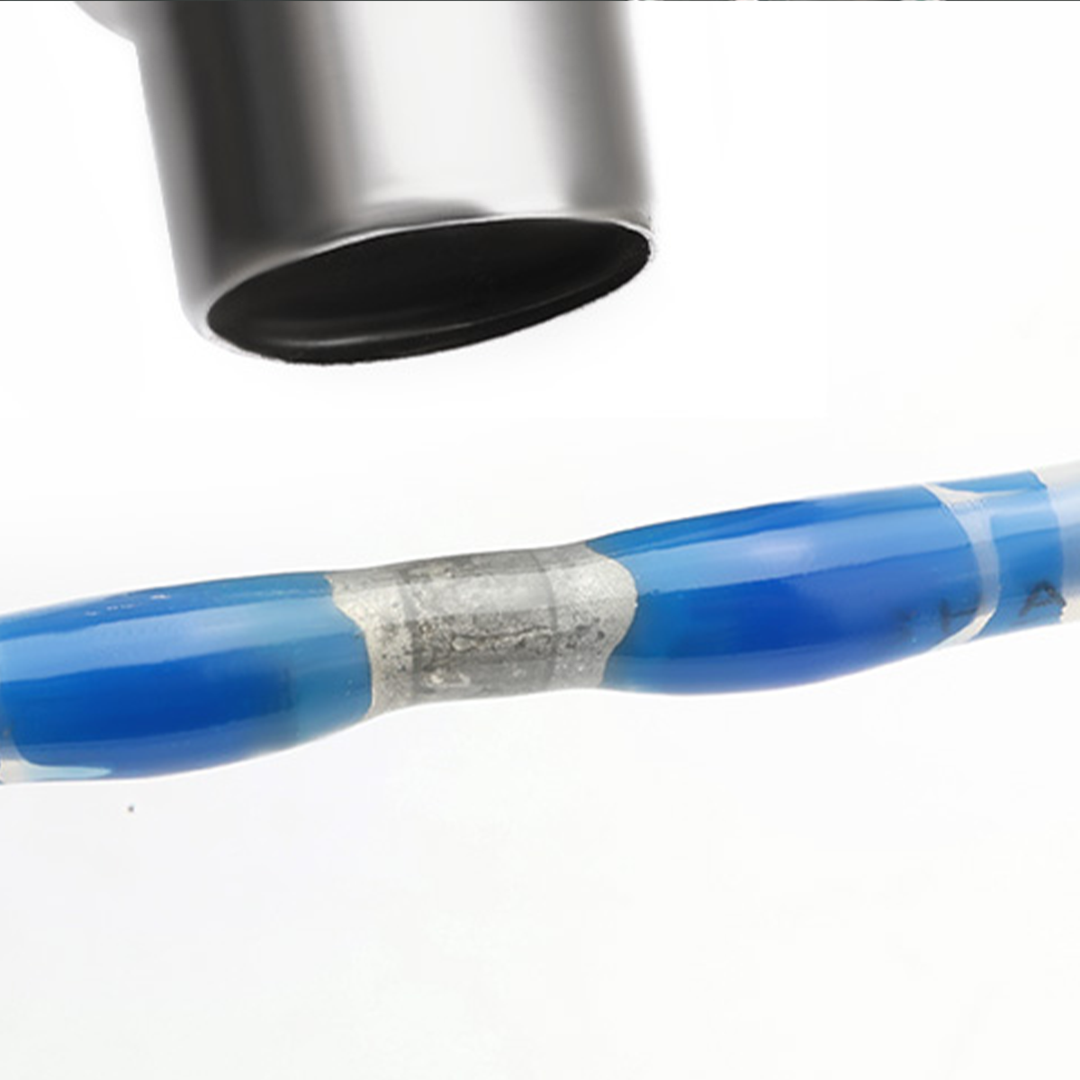 Heat shrink solder wire connectors on blue wire. Silver sleeve, precise joint.