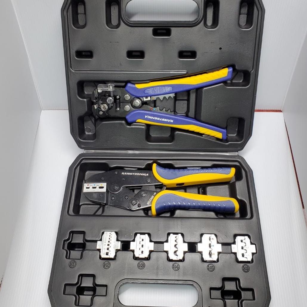 High-performance electrical crimp tools set in protective case, complete with multiple die heads for versatile terminal crimping.