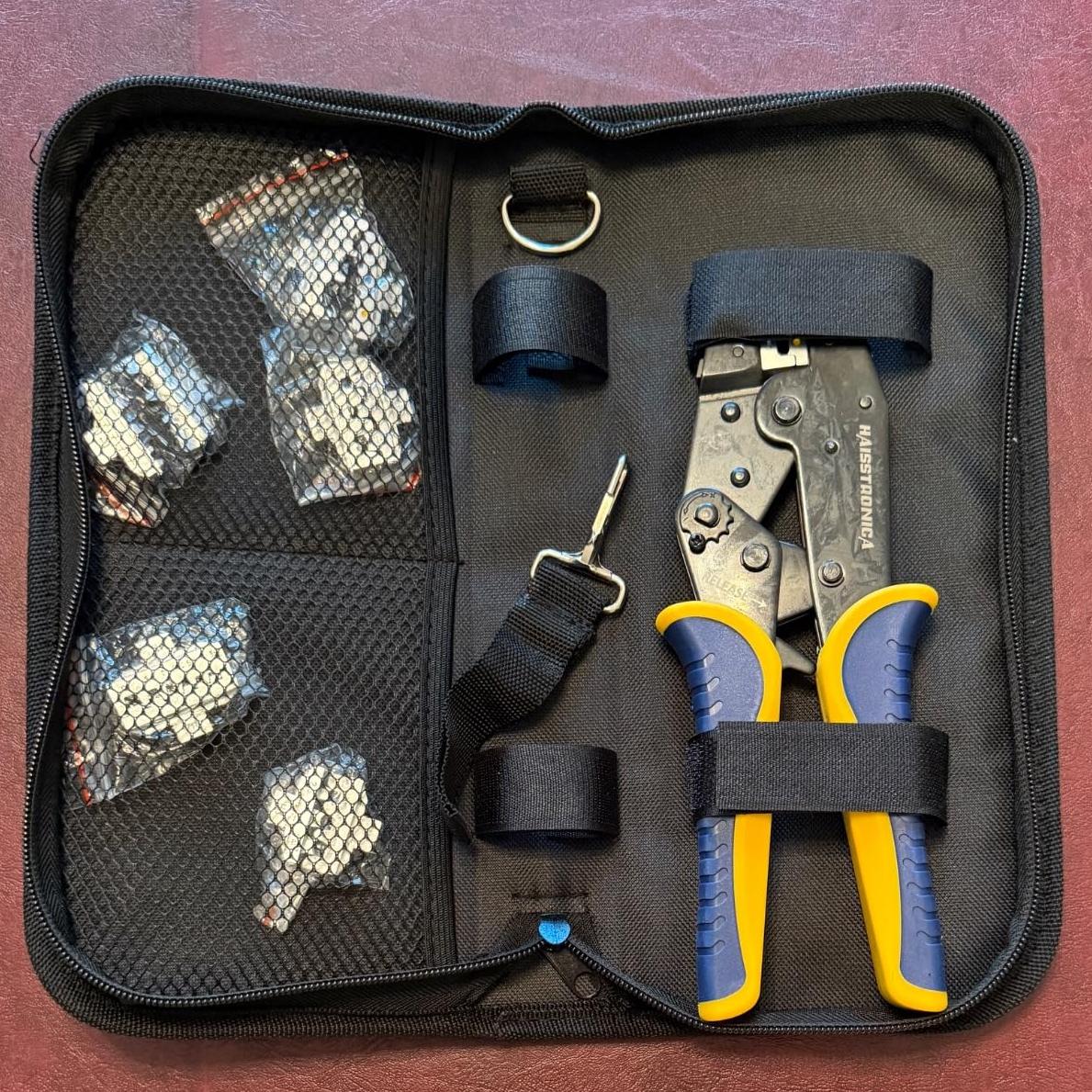 Compact wire connector crimpers kit with organized storage bag, interchangeable dies, and ergonomic handles for easy operation.