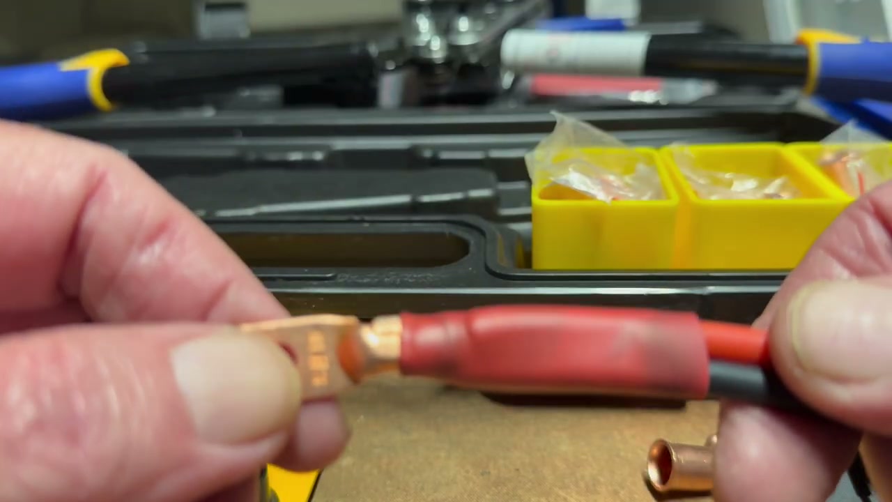 Authorized JonesingForTools video frame showing a finished battery cable terminal connection