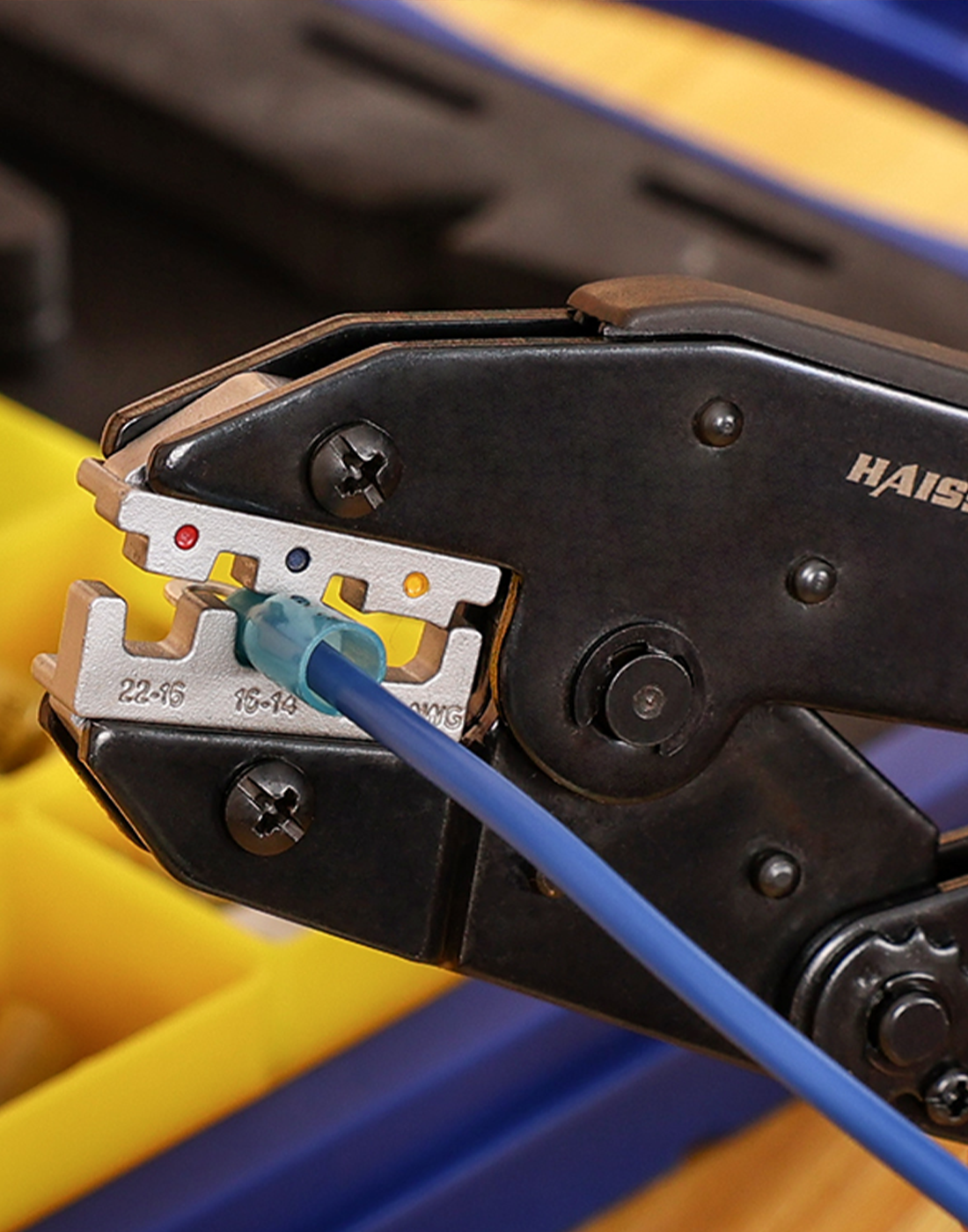 Haisstronica ratchet crimper securing a blue heat shrink connector on electrical wire